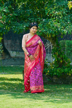 Dazzling Vibrant Purple Patola Silk With Contrast Magenta Border and Intricate Animal Motifs