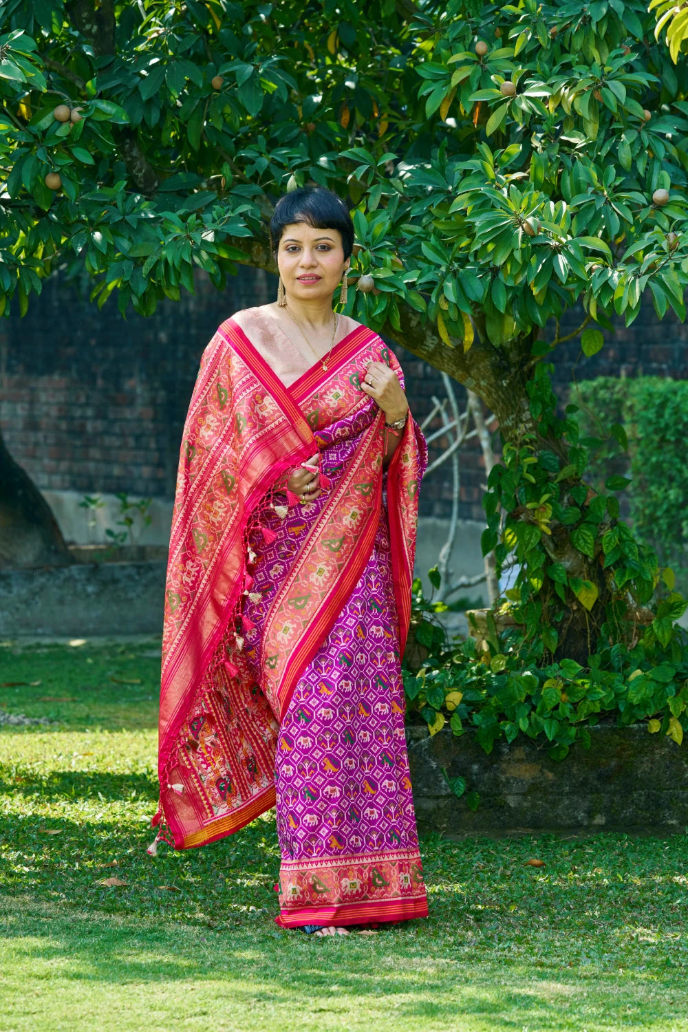 Dazzling Vibrant Purple Patola Silk With Contrast Magenta Border and Intricate Animal Motifs